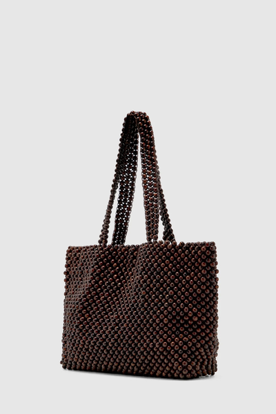 Studio front three-quarter product shot of the dark chocolate beaded tote bag, highlighting the structured silhouette and dual top handles.