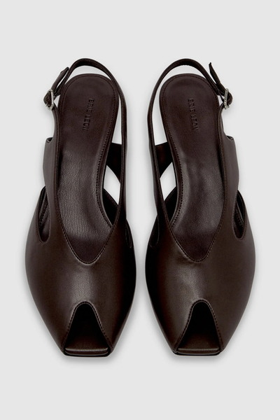 Top-down view of a pair of dark chocolate brown Brie Leon Sadie Peep Toe Heels, showcasing the peep-toe front opening, sleek side cut-outs, silver slingback buckles, and embossed brand logo on the footbed.
