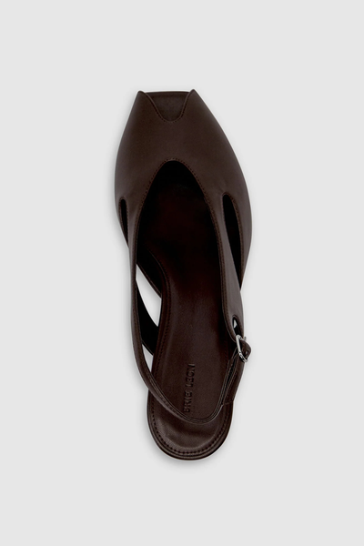Overhead detail shot focusing on a single dark chocolate brown Brie Leon Sadie Peep Toe Heel, highlighting the smooth bio-based corn leather upper, inner side cut-out, and silver adjustable heel strap buckle.