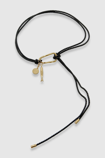Studio flat-lay product shot of the black hand-braided recycled leather Scout belt with a gold carabiner, fish charm, and coin medallion against a clean white background.