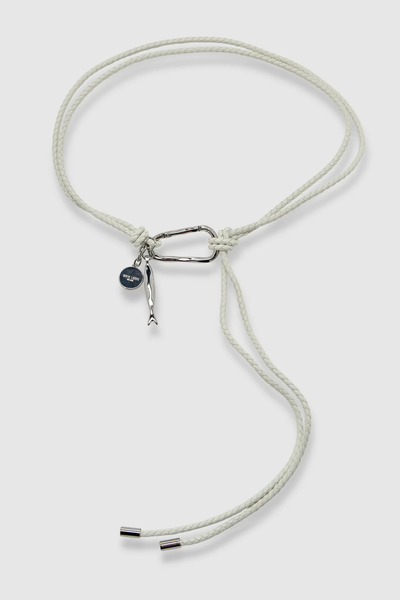 Studio flat-lay product shot of the elderflower hand-braided recycled leather Scout belt with a silver carabiner, fish charm, and coin medallion against a clean white background.