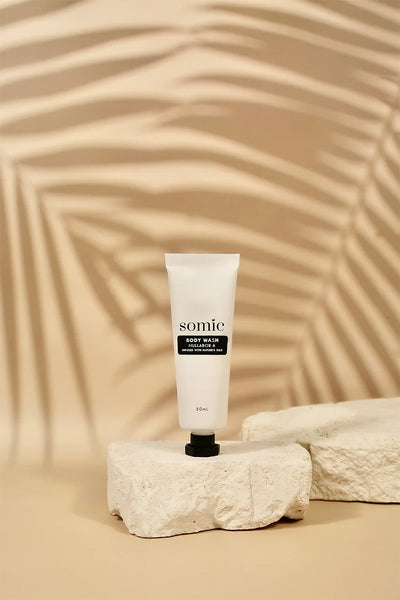 Tube of somic cream on a textured beige background