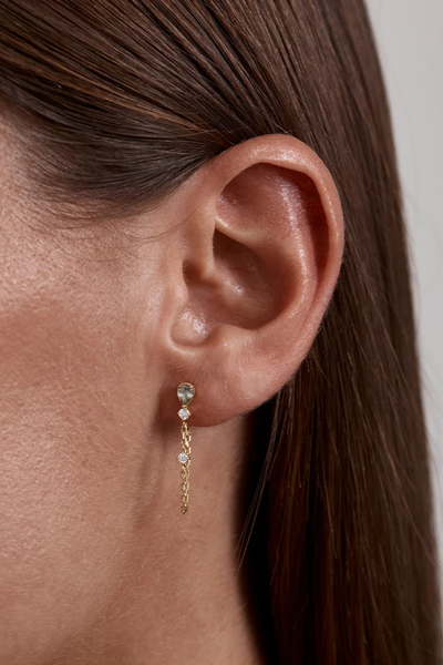 Alternate lifestyle view showing the By Charlotte Aura Chain Earring in 18k Gold Plated worn unlooped as a straight chain drop earring.