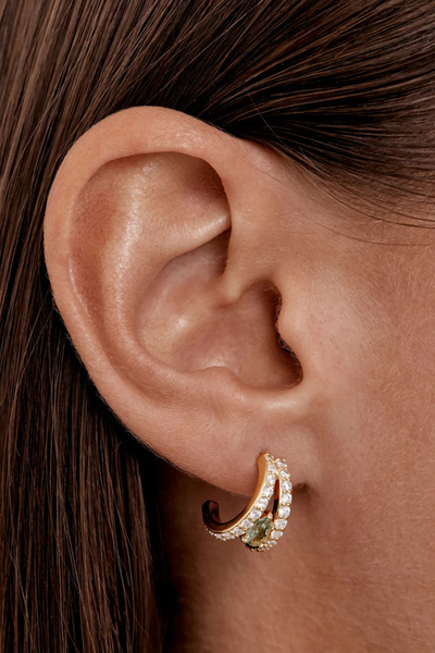 On-model lifestyle view demonstrating the By Charlotte Aura Illusion Hoop in 18k Gold Plated worn in an earlobe piercing, creating a double-hoop stacked effect.
