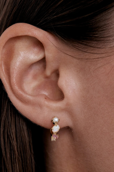 On-model lifestyle view showing the By Charlotte Cosmic Bloom Hoop in 18k Gold Vermeil styled in an earlobe piercing.