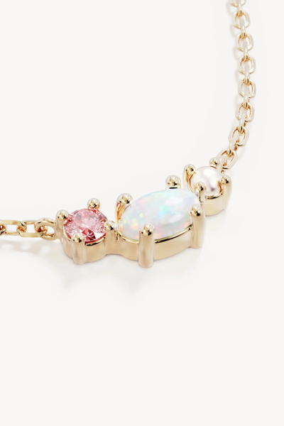 Macro close-up shot of the By Charlotte Cosmic Bloom Necklace in 18k Gold Vermeil, highlighting the claw-set pink cubic zirconia, oval lab-grown opal, and freshwater pearl cluster.