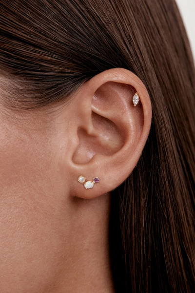 On-model lifestyle detail view showing the By Charlotte Cosmic Bloom Stud Earring in 18k Gold Vermeil styled in an earlobe piercing.