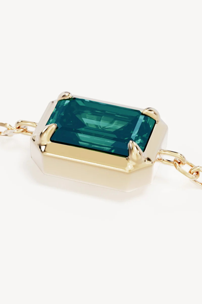 Extreme macro close-up product view detailing the emerald-cut deep green nano tourmaline Paraiba stone set in a claw bezel frame on the By Charlotte Trust Your Intuition Bracelet in 18k Gold Vermeil.