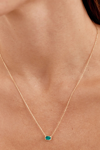 Lifestyle view of a model wearing the By Charlotte Trust Your Intuition Necklace in 18k Gold Vermeil, showcasing the length and pendant placement on the chest.