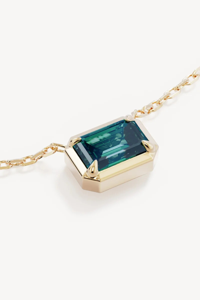 Macro close-up shot of the By Charlotte Trust Your Intuition Necklace in 18k Gold Vermeil, highlighting the claw-set 7.5 x 5.5mm emerald-cut green nano tourmaline Paraiba