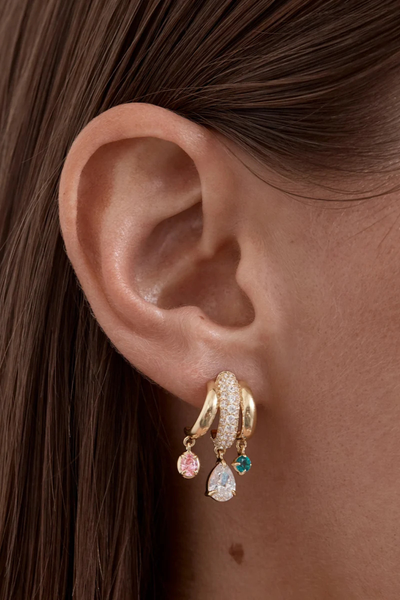 Close-up lifestyle view of the By Charlotte Vibrant Soul Illusion Hoop in 18k Gold Plated on-model, detailing the dangling pink, clear, and teal gemstone drops.