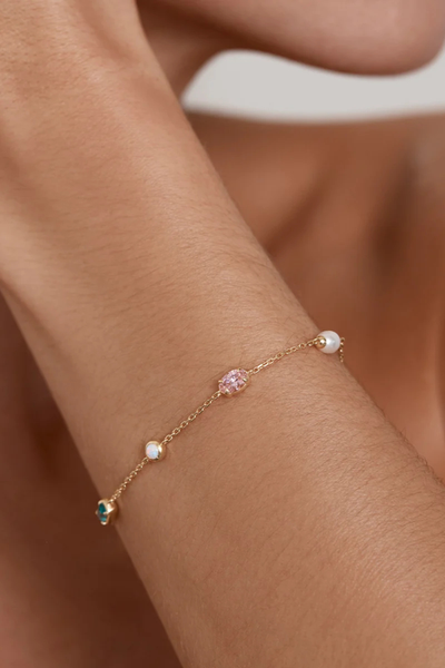 Alternative on-model angle showing the By Charlotte You Are Infinite Bracelet in 18k Gold Plated styled on the wrist in natural lighting.