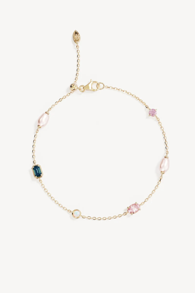 Studio product shot of the By Charlotte You Are Infinite Bracelet in 18k Gold Plated, showcasing a delicate cable chain bracelet set with colorful gemstones including freshwater pearls, pink cubic zirconia, and a green tourmaline charm, complete with a lobster clasp closure.