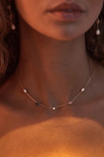 Editorial lifestyle shot of a model wearing the By Charlotte You Are Infinite Choker in 18k Gold Plated, set against warm ambient lighting.
