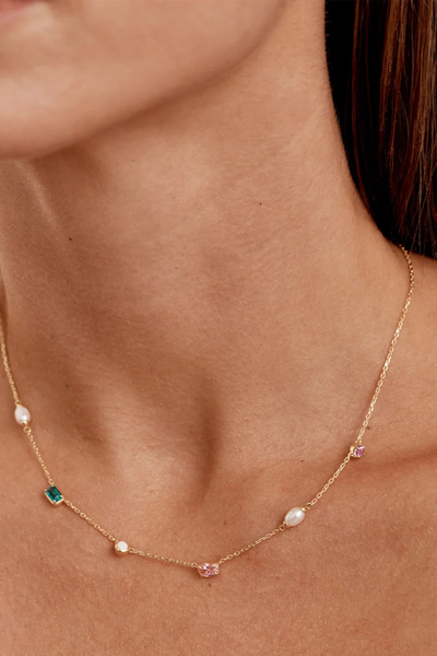 On-model lifestyle detail view of the By Charlotte You Are Infinite Choker in 18k Gold Plated worn high on the neckline, showcasing the multi-gemstone arrangement.
