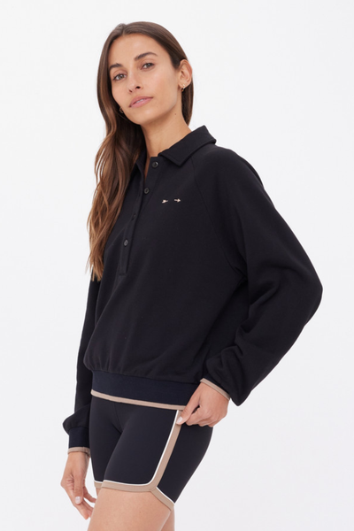 A side-angle shot focusing on the ribbed cuff with a distinctive mocha stripe trim for a polished sport-luxe look.