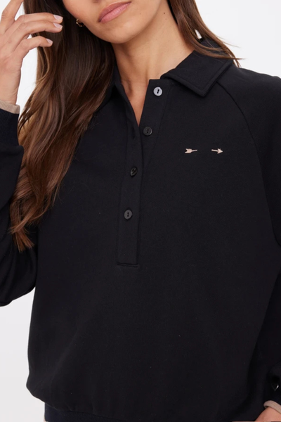 A close-up view of the collar and button-down front, emphasizing the technical design and high-quality hardware.
