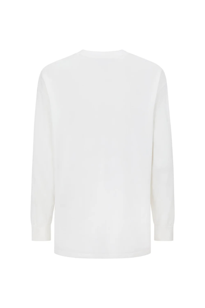 A full back view of the garment on a model, highlighting the seamless yoke area across the shoulders and a clean, unembellished minimalist aesthetic.