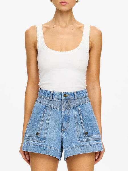 Full-length front view of the light blue Stonewash denim shorts, highlighting the modern high-waisted fit and antique brass logo hardware.