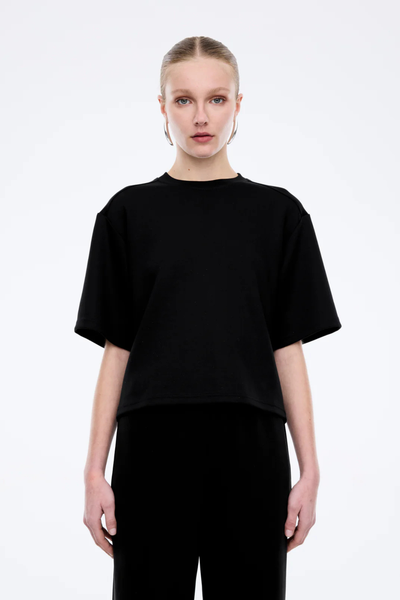 Front view focusing on the clean-cut ribbed crew neckline and the high-quality tonal stitching of the black jersey top.