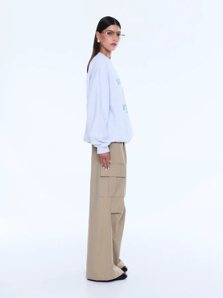 Side view of the Mila Oversized Sweater in White Marle, showing the clean, expansive back panel and the slouchy, comfortable drape of the dropped shoulders.