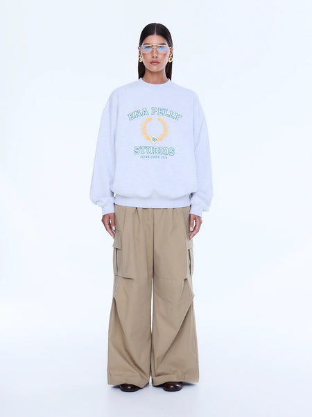 Model wearing the Mila sweater, illustrating the relaxed crew neck, dropped shoulders, and the generous, voluminous oversized fit on a 176cm frame.