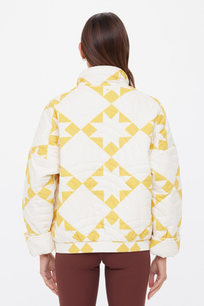 A full back view of the Etoile Carmen Jacket, showcasing the continuous star print and the clean lines of the insulated stripe quilting.