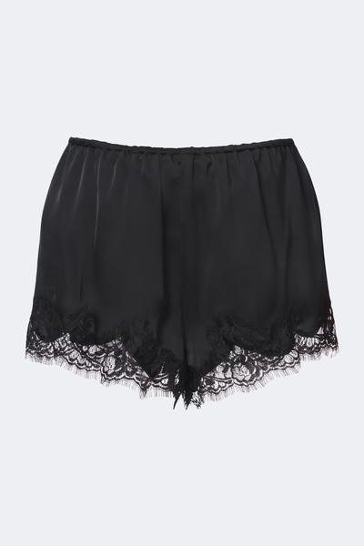 Flat-lay front product shot of the black wide-leg satin shorts featuring an elasticated waist and scalloped lace hems against a plain light background.