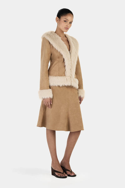 A three-quarter side angle view on a model, demonstrating the fluid fit of the polyester-spandex blend outerwear piece and the structural framing of the wide shawl collar.

Back View