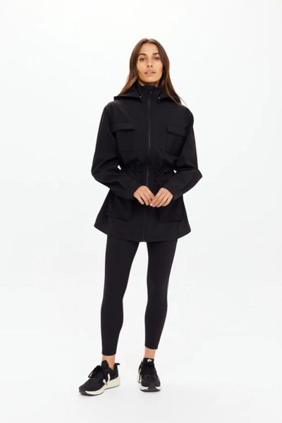 Lifestyle campaign image of the Freddie Fleece Lined Anorak styled in an outdoor coastal setting, demonstrating its versatility as a transitional lifestyle and performance jacket.