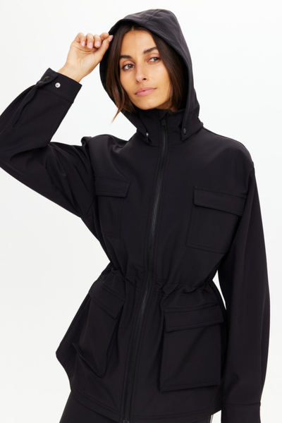 Close-up of the sleeve cuff and gathered waistline, illustrating the durable technical fabric and the adjustable snap-button cuff closures.