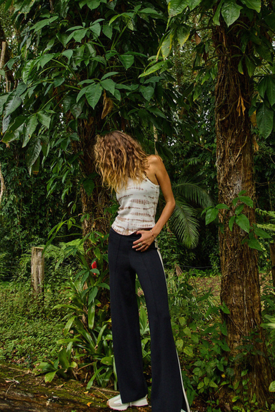 A lifestyle image showing the Freya Knit Pant styled for a versatile, "athluxury" look suitable for travel or everyday wear.