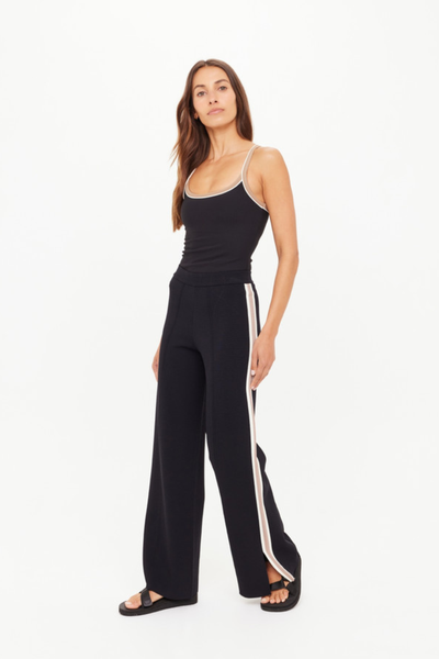 A three-quarter view of the black knit pants, demonstrating the easy, tailored drape and the comfortable elasticated waistband.