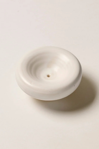 High-angle studio product shot of the Gentle Habits Vessel Incense Holder in Cream, showcasing its smooth circular form and soft matte cream glaze.
