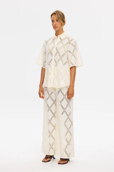 ull-length studio shot of a model wearing the KIVARI Izzy Shirt in Cream styled as a matching set with the Izzy wide-leg pants.