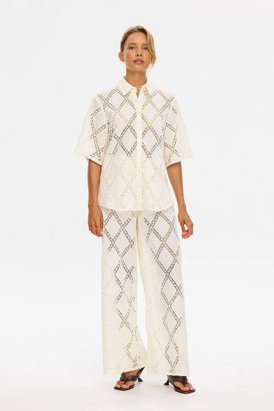Studio full-length image of a model showcasing the complete KIVARI Izzy set in Cream with dark heel sandals.