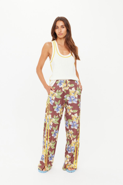 A full-length front view of the low-rise botanical pants on a model, highlighting the relaxed fit and how the floral pattern distributes across the lyocell-cotton blend fabric.