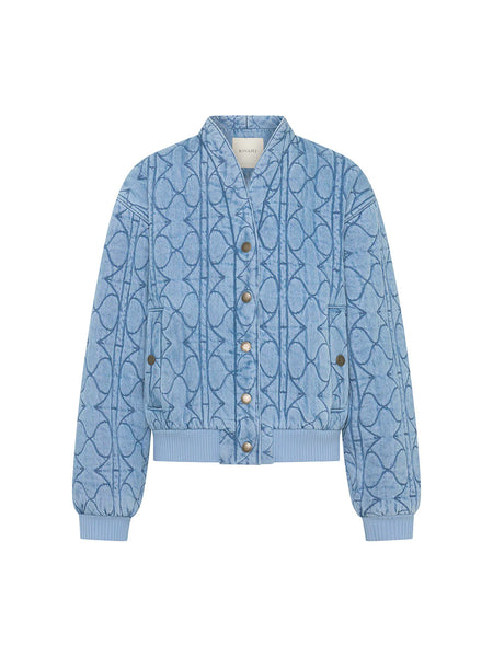 The quilted denim jacket in Pale Stone, showcasing the clean round neckline and flat-lay structure of the signature logo hardware.