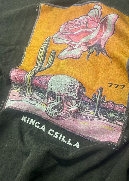 Close-up texture detail of the hand screen-printed desert graphic on the Kinga Csilla Desert Rose OG Tee in stonewashed black cotton jersey, featuring a skull, rose, and cactus illustration with vintage texture.