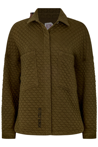 A clean, front-facing of the khaki button-through shirt isolated on a white background. The image clearly showcases the boxy, relaxed silhouette, the distinct bubble-textured Sabbia quilted design, two oversized front chest patch pockets, a sharp collar, and the black "Kinga Csilla" branding embroidered vertically near the lower right hemline.