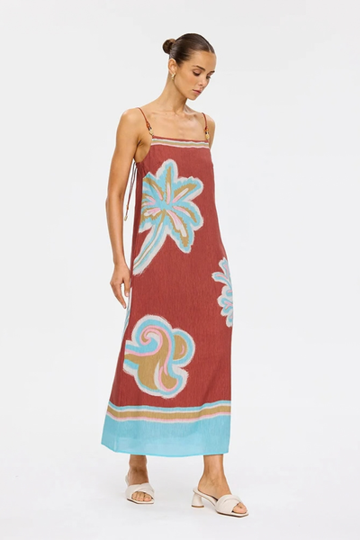 Studio full-length side-angle view of a model walking in the column-shape Enzo midi dress, highlighting the side seam split for fluid movement.