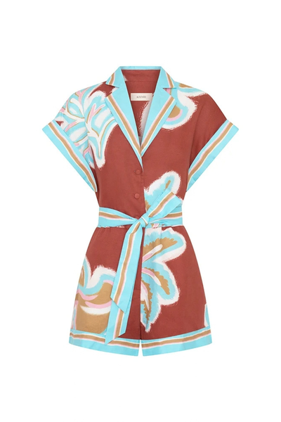 Flat product shot of the Kivari Enzo playsuit against a clean white background, showcasing the linen-cotton fabric, collar, rolled cuffs, and vibrant placement prints.