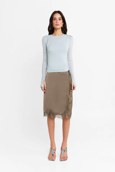 Front-facing studio full-length view of a model wearing the powder blue Kova top against a clean white background.