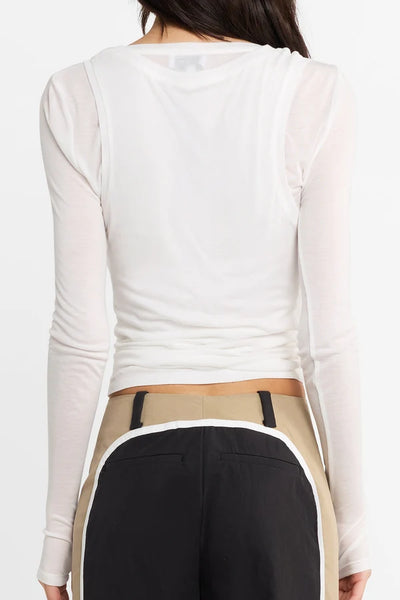 Close-up studio rear view focusing on the double scoop neckline and back detailing of the white fitted long-sleeve top.