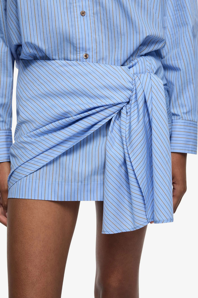 Close-up of the Chambray Blue cotton stripe blend, highlighting the fine vertical pinstripes and the smooth, lightweight texture of the fabric.
