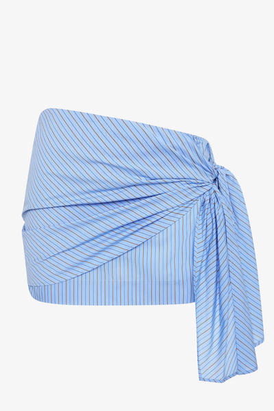 A wrap-style Linus Mini Skirt in Chambray Blue and white stripes, featuring a decorative side-seam tie and a clean mini length.