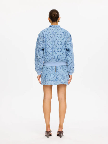 A full back view of the Joey Denim Jacket on a model, demonstrating the uniform flow of the signature diamond and wavy quilting pattern across the broad back panel.