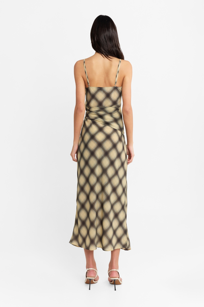 Studio rear view of a model wearing the check maxi dress, highlighting the straight back neckline, thin shoulder straps, and fluid silhouette.