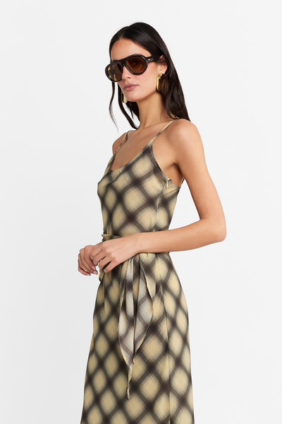 Side profile close-up of a model wearing the check maxi dress, showcasing the wrap tie belt detail and lightweight fabric.
