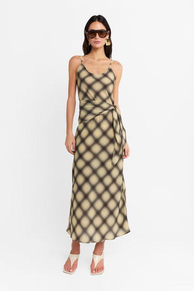 Full-length studio front view of a model wearing the Eloise Maxi Dress in Check, styled with a scoop neckline, adjustable spaghetti straps, wrap tie, and cream heels.